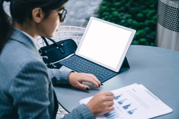 Woman surfing laptop and checking graphs