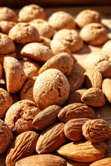 Macro of almonds and amaretti cookies in the background. italian cantuccini cookies, sweet almond biscuits.
