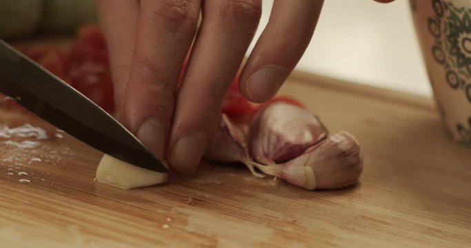 Cutting onion and tomatoes on a chopping board
