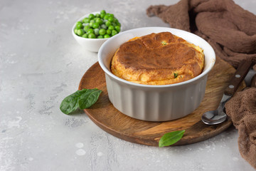 Green peas and cheese souffle on a wooden plate. Protein breakfast.