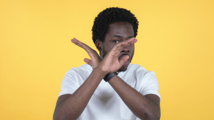 Disliking Casual African Man Rejecting Offer Isolated on Yellow Background