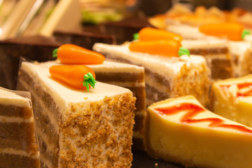 Tasty fresh cakes in showcase. Bakery in cafeteria. Baked croissants, carrot and chocolat cake. Pastry closeup. Sweet delicious breakfast. Morning baking in cafe. Homemade cookery. Dessert concept. 