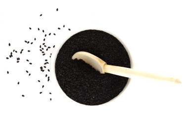 Fototapeta na wymiar black seeds with a wooden spoon