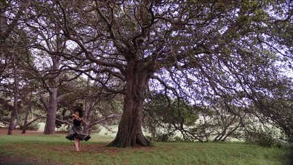 The Dancer In Black Ensemble Performing A Modern Ballet Dance Featuring A Grande Battement In The Air And A Grand Jeté. -wide shot