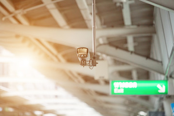 CCTV hanging on ceiling of train station with light fair,Security,Camera
