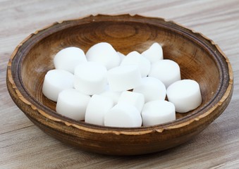 Pile of softener salt pellets in the bowl. Good for  eco friendly cleaning the dishes