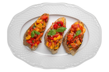 Tasty Vegetarian bruschetta with baked peppers with tomatoes and cheese. Easy cook, nutritious snack. Beautifully decorated catering banquet menu. Food and appetizers for buffet. Isolated on white