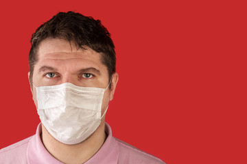 Portrait of adult caucasian man who wears protective mask on his face against influenza and protect health from bacteria.