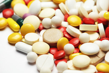 Different colorful tablets at white background