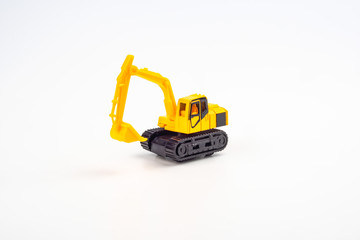 Yellow toy excavator isolated on white background.
