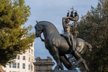 A sculpture on the square in Barcelona, Spain. The monument in the form of a girl on horseback on a sunny day in Barcelona.