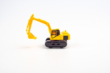 Yellow toy excavator isolated on white background.