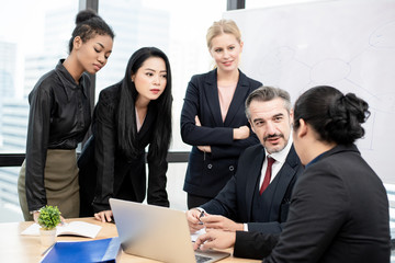 Ethnic diversity business groups  are delighted with the results of their work on the laptop. Co-working, teleworking, Online business conference concept.