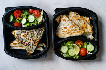 Turkish Take Away Food Gozleme Made with Flat Bread and Salad in Plastic Container Box Plate.