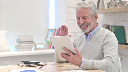 Online Video Chat on Tablet by Senior Old Businessman