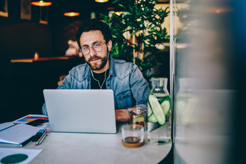Concentrated male employee working on business project in cafe