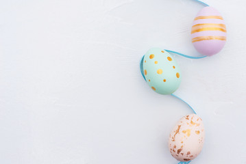 Pretty Colored Easter Eggs on blue Ribbon isolated on white background with copy space