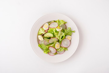 Healthy vegetables salad with cucumbers, quaill eggs and radish. Fresh vegetables salad isolated on...
