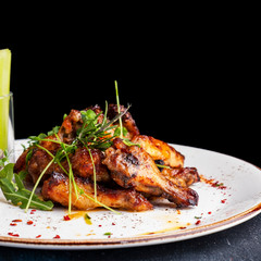 BBQ chicken wings on a plate. Copy space