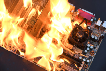 Fire Burning ,blazing computer motherboard, cpu,gpu and video card, processor on circuit board with electronic