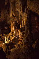 Vertical picture of stalagmites and stalactites in Aven d'Orgnac cavern in Ardeche departement, France. Famous speleology travel tourism destination