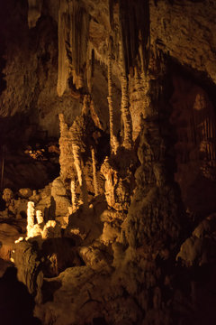 Vertical picture of stalagmites and stalactites in Aven d'Orgnac cavern in Ardeche departement, France. Famous speleology travel tourism destination