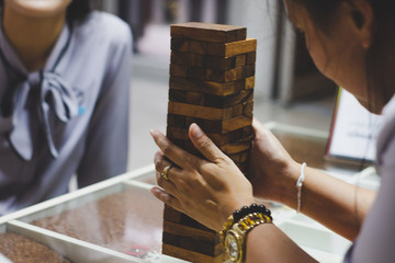 Obraz premium Close up woman playing jenga block. For business success concept