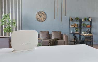 Modem on the white table and living room background style. - obrazy, fototapety, plakaty