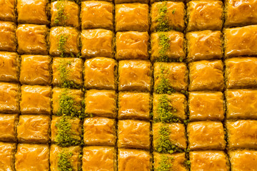 Traditional Turkish dessert baklava background.Powder of pistachio garnished.