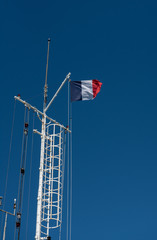 French flag floating on a blue sky