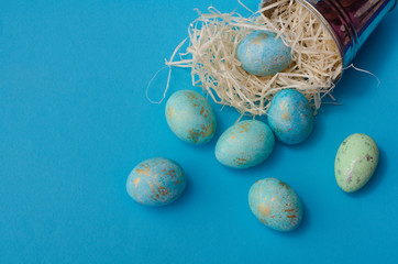 Easter blue eggs in bucket with decor.  Minimal easter concept. Easter card with copy space for text.