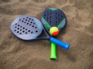 Beach tennis rackets in the sand