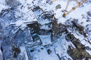 Aerial panoramic shot of granit mining quarry at winter.