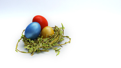 colorful Easter eggs in a nest of young willow branches