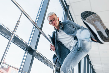 Cheerful young male student have fun. Close up view of foot