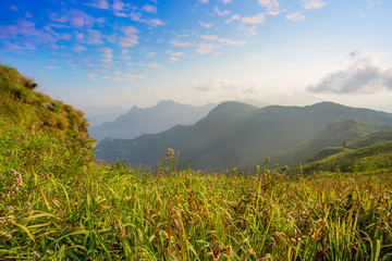 Scenic View Of Foggy Morning Sky With Rising Sun Above Misty Mountain. Fog and cloud mountain...