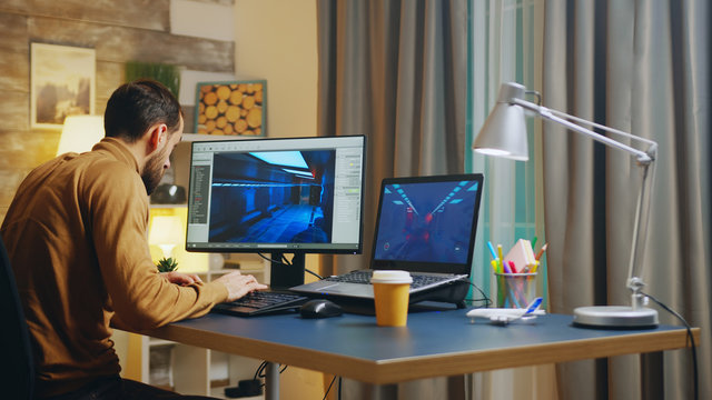 Back View Of Of Young Game Developer In His Home Office