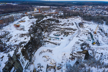 Aerial panoramic shot of granit mining quarry at winter.