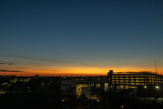 Night sky just after sunset as background over the city with a few lights on.
