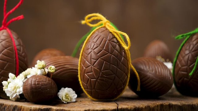 easter chocolate egg rotating on wooden board