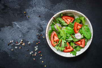 healthy salad tomato, mix leaves, onions and other ingredients, vegan, keto or paleo menu concept. top food background. copy space for text