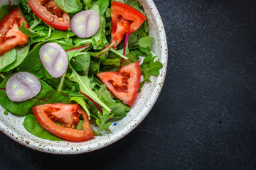 healthy salad tomato, mix leaves, onions and other ingredients, vegan, keto or paleo menu concept. top food background. copy space for text