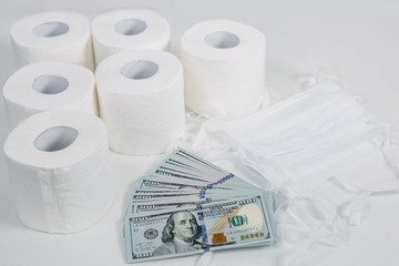 toilet paper rolls dollars and masks on a light background