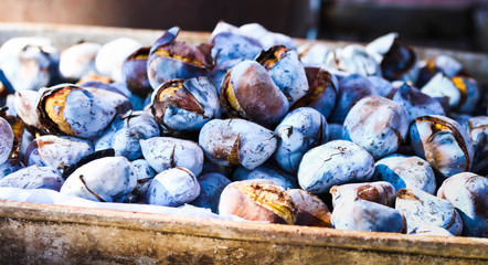 Set of roasted chestnuts for sale in traditional trade. Appetizing edible fruit.