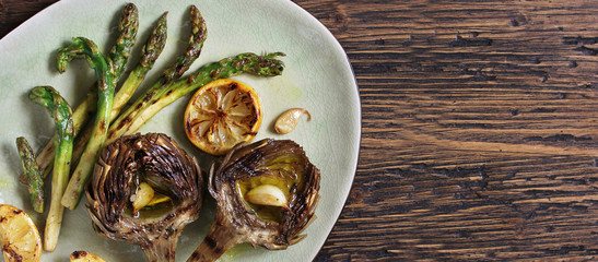  artichoke and asparagus grill. Tasty vegetables are first cooked for a couple, then fried on a grill, poured with olive oil and spices. spring vegetables. Flatlay.  copy space. top view
