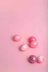 Pink colored eggs on a pink background.