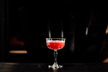 cocktail in a dark key, on a dark background, with different metal details