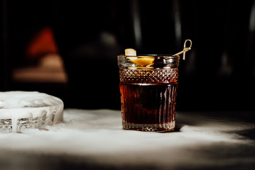 cocktail in a dark key, on a dark background, with different metal details