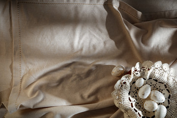 Eggs with Flat light brown beige linen background seen from above with copy space for advertising products.