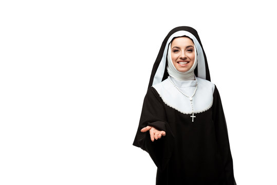 beautiful smiling nun in black clothing reaches out hand, isolated on white